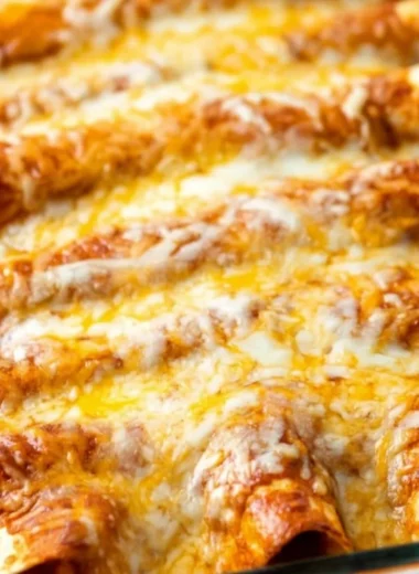 Delicious restaurant-style red cheese enchiladas topped with sauce and cheese