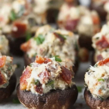 Stuffed mushrooms with bacon, cream cheese, and green onions on a platter