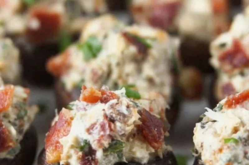 Stuffed mushrooms with bacon, cream cheese, and green onions on a platter