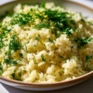 Plate of Authentic Greek Lemon Rice garnished with fresh herbs