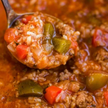 Bowl of Instant Pot stuffed pepper soup with peppers and herbs