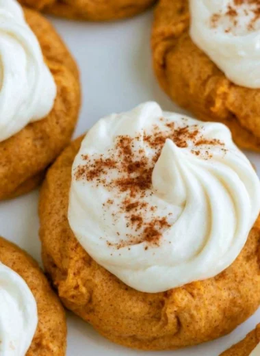 Delicious pumpkin cookies with cream cheese frosting on a plate