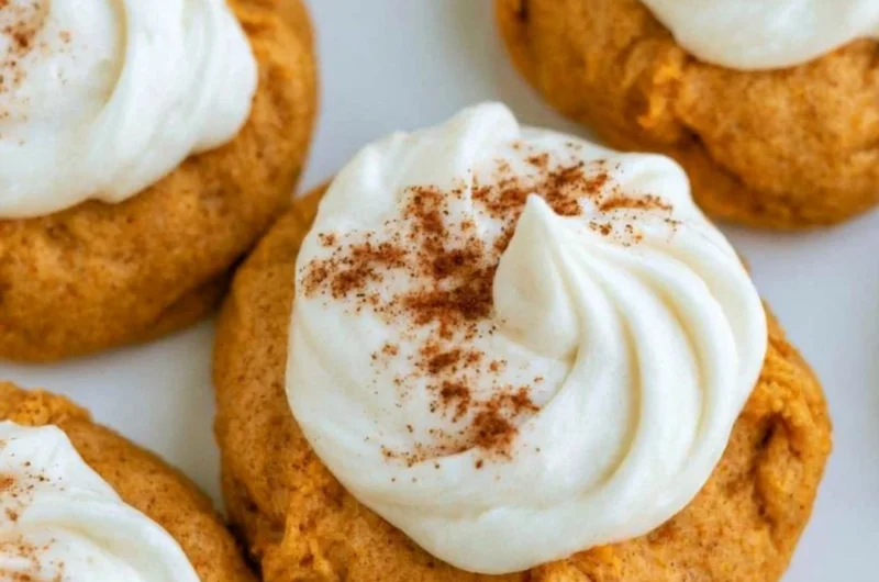 Delicious pumpkin cookies with cream cheese frosting on a plate