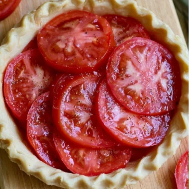 Delicious Southern Tomato Pie with fresh tomatoes layered in a flaky crust