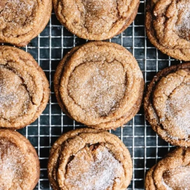 Freshly baked molasses cookies on a cooling rack, golden and chewy
