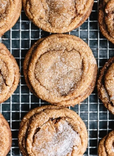 Freshly baked molasses cookies on a cooling rack, golden and chewy