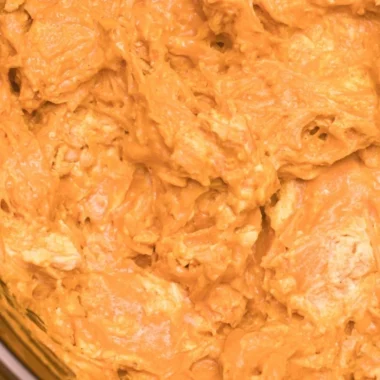 Creamy and spicy Crockpot Buffalo Chicken Dip served in a bowl with tortilla chips.