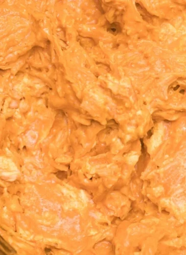Creamy and spicy Crockpot Buffalo Chicken Dip served in a bowl with tortilla chips.