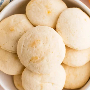 Plate of easy orange whipped shortbread cookies with zesty orange flavor.