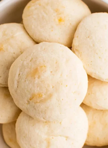Plate of easy orange whipped shortbread cookies with zesty orange flavor.