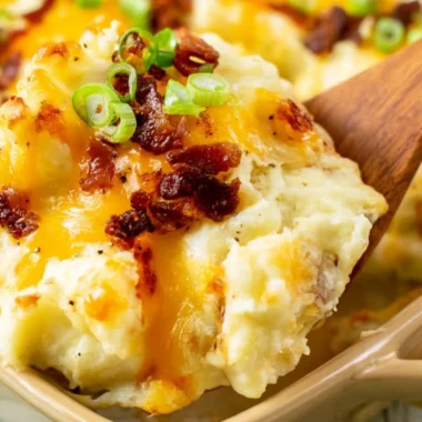 Delicious twice baked potato casserole presented in a baking dish by The Pioneer Woman.
