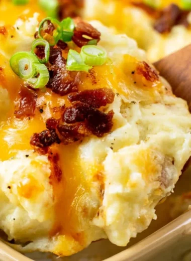 Delicious twice baked potato casserole presented in a baking dish by The Pioneer Woman.